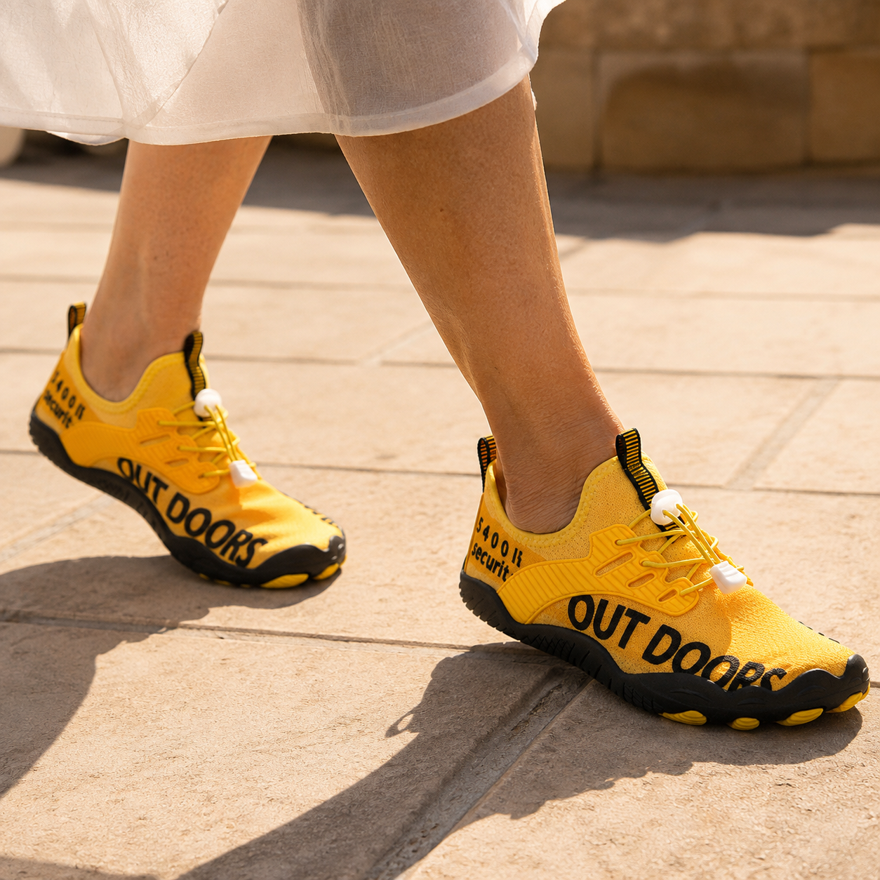 Folks Terra Yellow worn on a sunlit coastal path